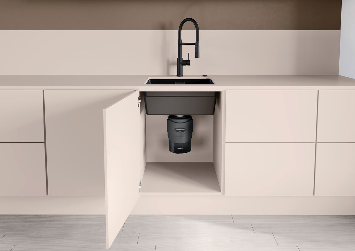 Black FWD medium waste disposal unit under sink cabinet, shown from front