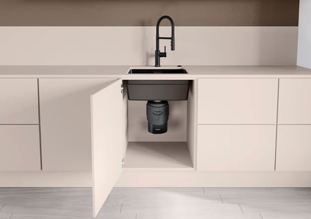 Black FWD medium waste disposal unit under sink cabinet, shown from front