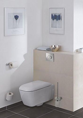 GROHE Skate Air WC wall plate on wall beside white toilet, chrome oval button