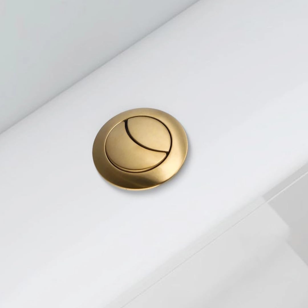 Brushed brass toilet flush button with circular dual-flush design on white cistern