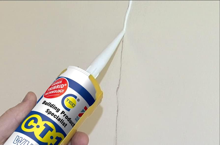 Hand applying clear CT1 sealant bead along a wall seam