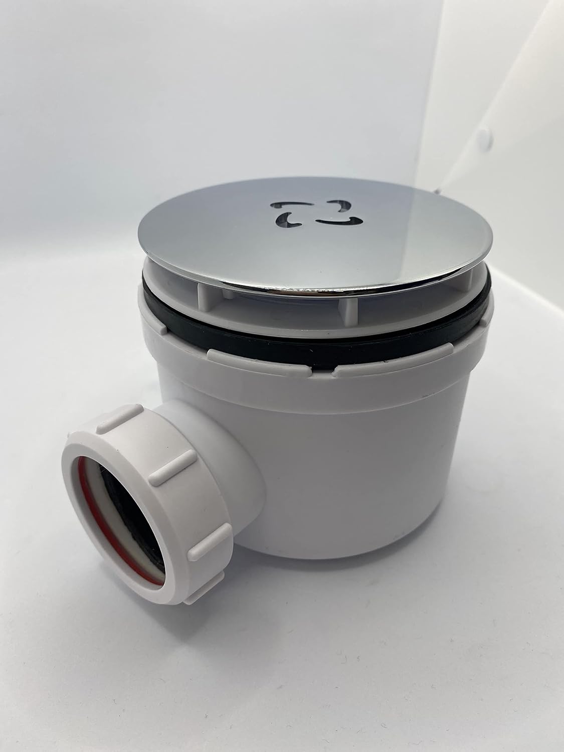Round matt black waste cover lid on waste valve with side connector