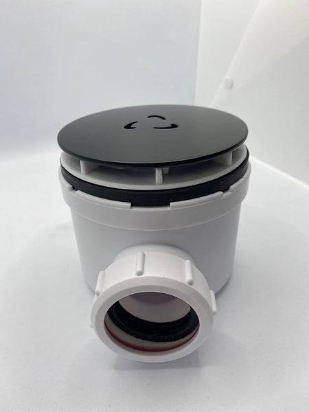 Round matt black waste cover lid on gray/white waste valve body