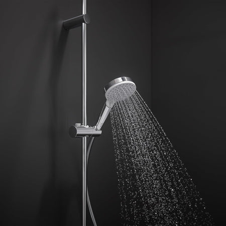 Chrome hand shower head spraying water, on vertical slide bar