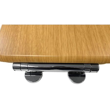 Oak-finish toilet seat hinge with chrome soft-close dampers and metal brackets