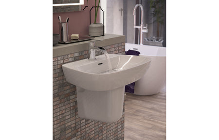 White basin with semi pedestal and faucet, front three-quarter view