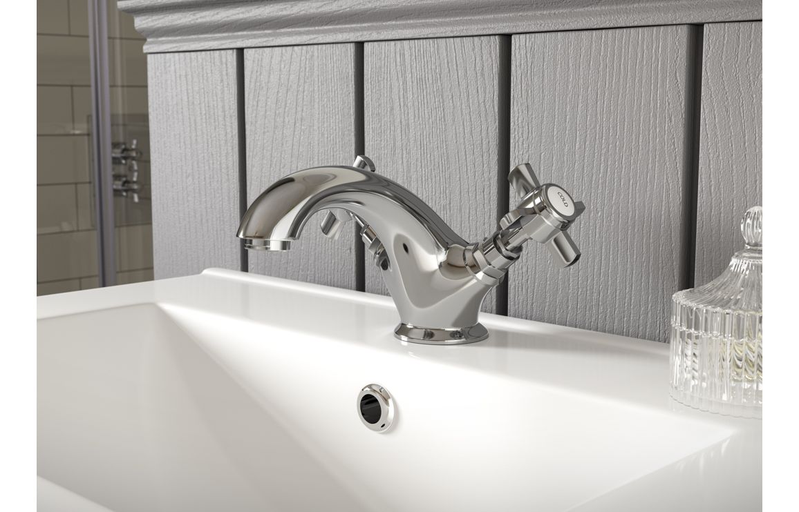 Chrome floor mixer tap with single lever and handheld shower on bathtub
