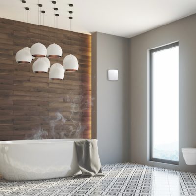Wall-mounted extractor fan on bathroom wall with white cover