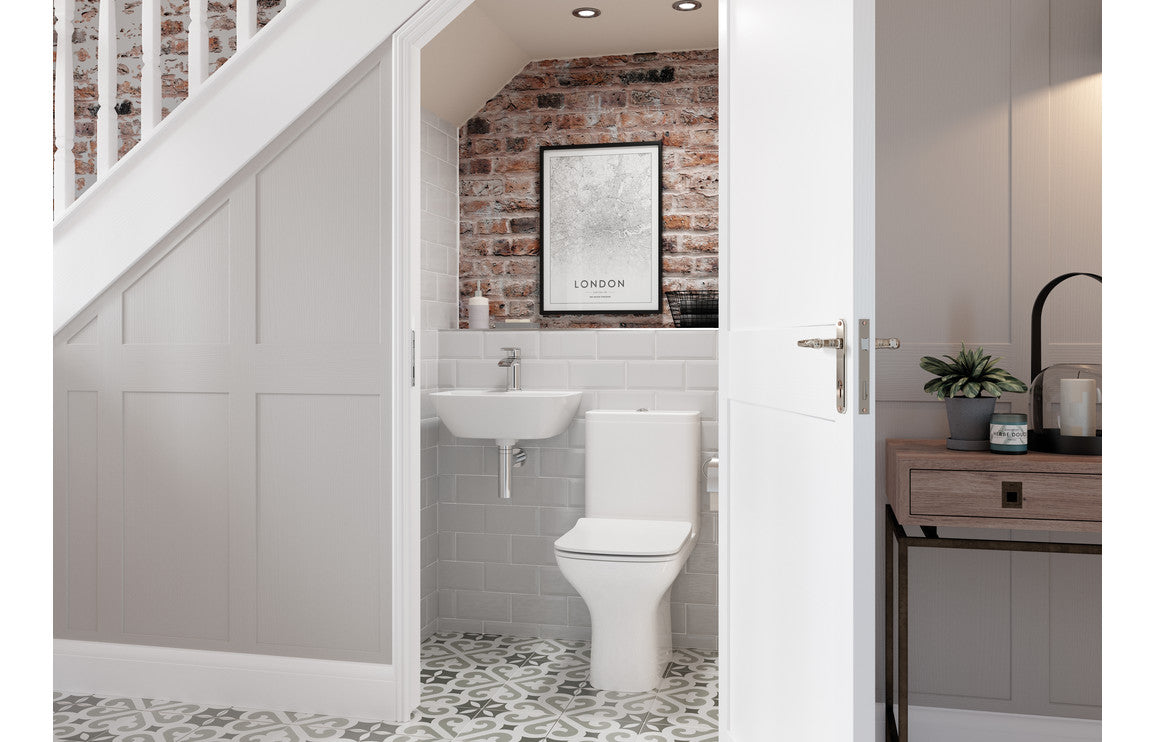 White pedestal basin with tap fitting, shown in a bathroom alcove