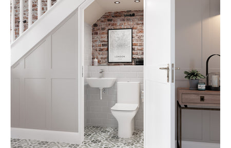 White pedestal basin with tap fitting, shown in a bathroom alcove