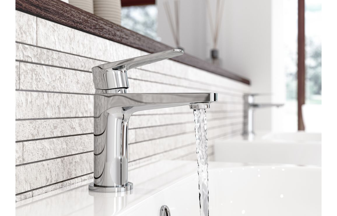 Chrome basin mixer tap with spout and lever, water flow over sink