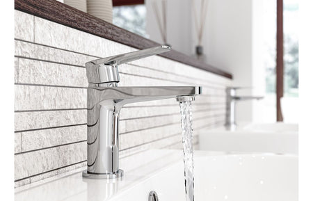 Chrome basin mixer tap with spout and lever, water flow over sink