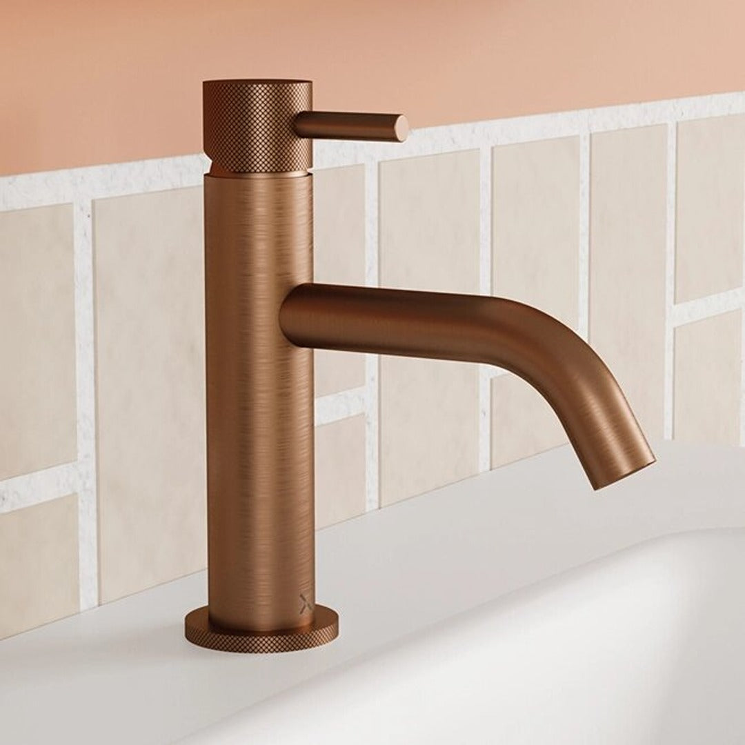 Brushed bronze basin mixer tap with knurled cylindrical handle and curved spout