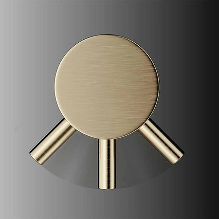 Brushed brass close-up of circular top with three outlet stems