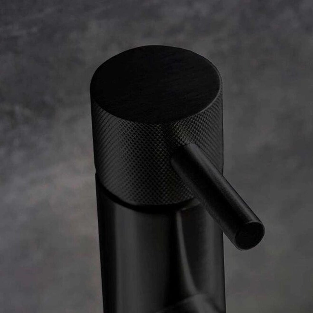 Matt black basin mixer tap close-up with knurled cylindrical handle