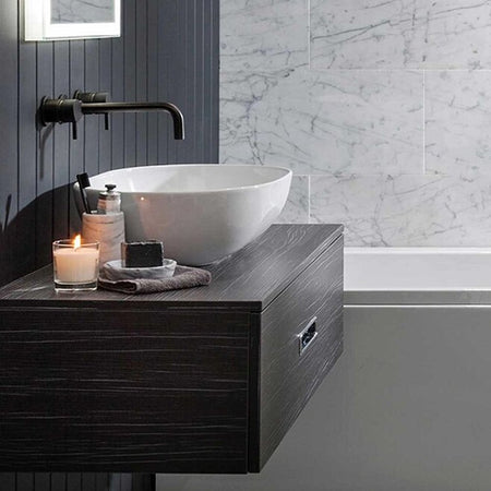 Wall-mounted black basin mixer with twin lever handles and curved spout