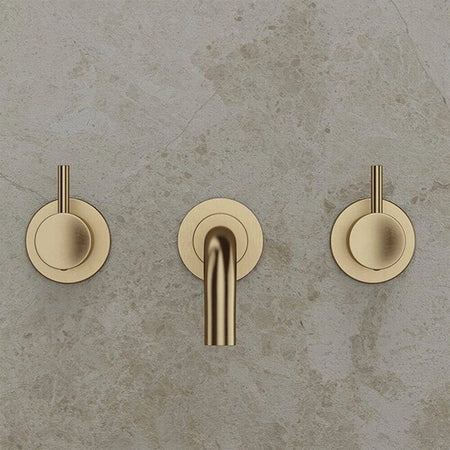 Brushed brass wall-mounted basin mixer with twin lever handles and spout outlet