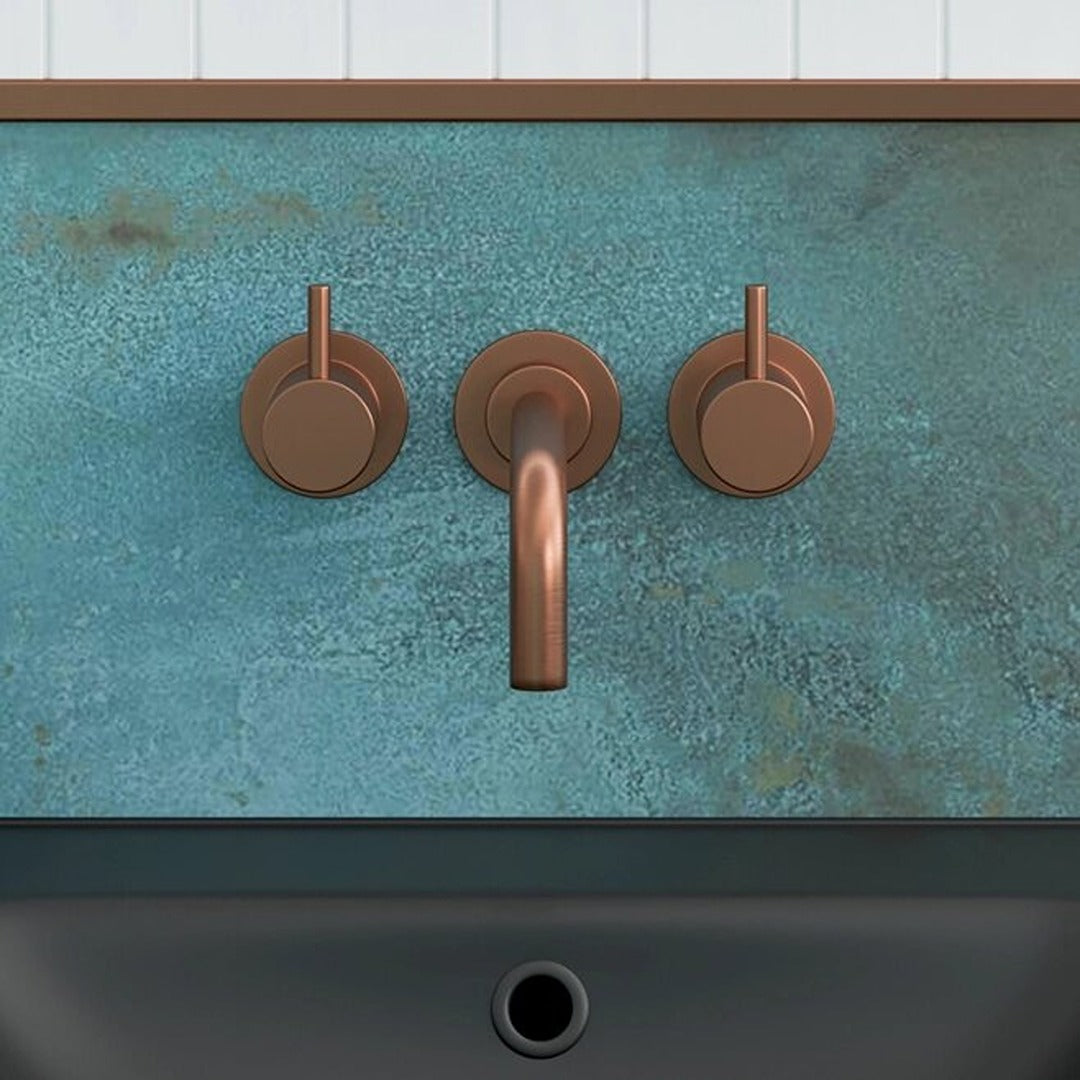 Wall-mounted basin mixer with twin lever handles and curved spout, bronze-colored finish
