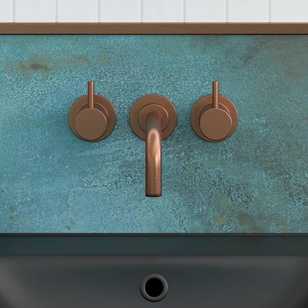 Wall-mounted basin mixer with twin lever handles and curved spout, bronze-colored finish