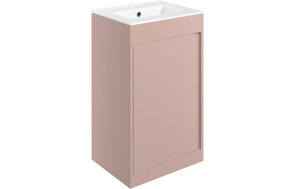 Matt pink floor standing vanity unit with integrated countertop basin and single door