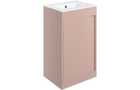 Matt pink floor standing vanity unit with integrated countertop basin and single door