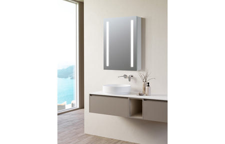 Wall-mounted LED mirror cabinet with illuminated vertical strips above vanity basin