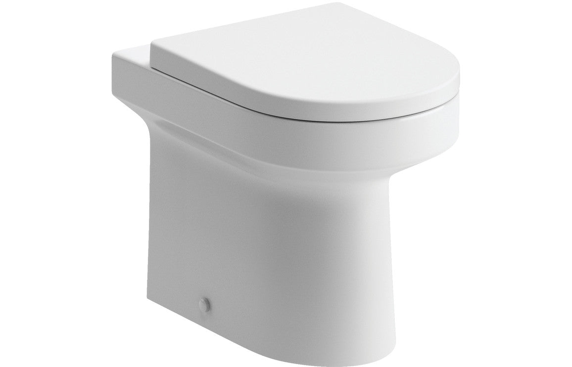 White toilet pan with rounded seat and front flush button detail