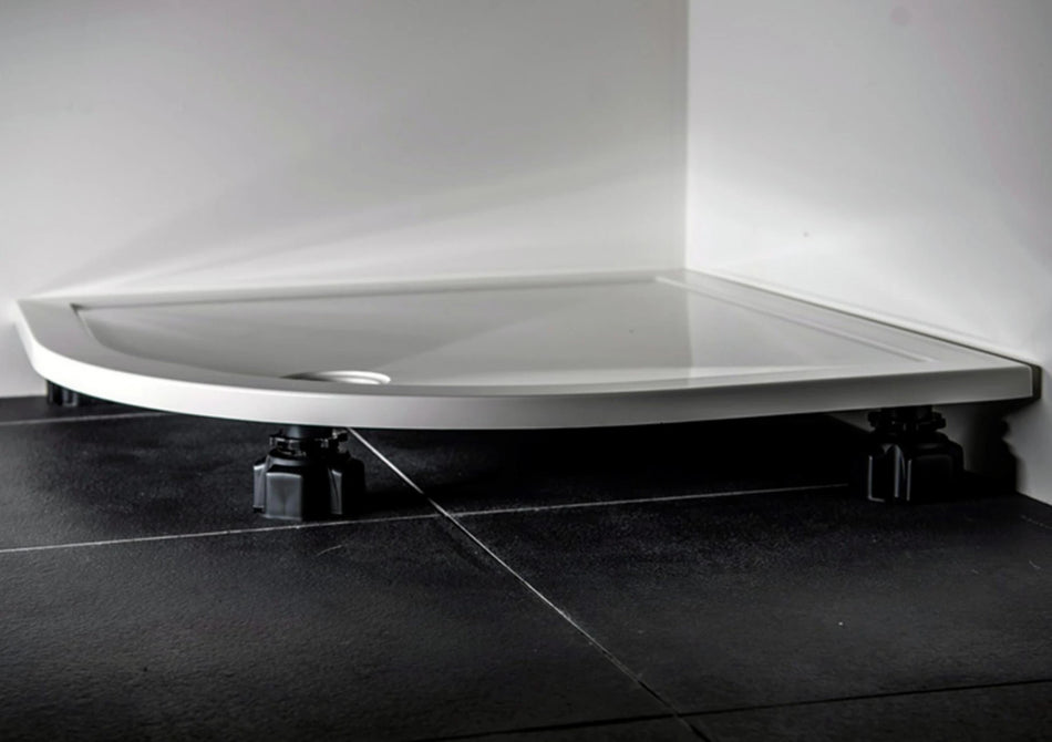 White shower tray riser kit with adjustable black support feet underneath