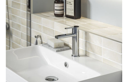 Chrome basin mixer tap installed on a white countertop basin