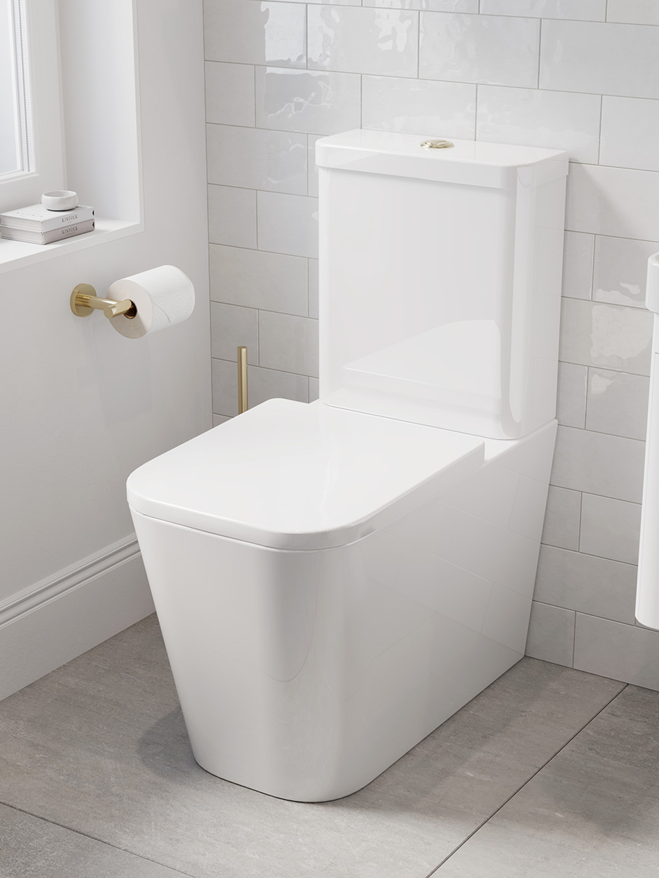Brushed brass toilet flush button on wall with two rods, paired flush handle