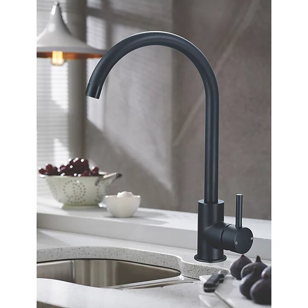 Matt black single-lever kitchen mixer tap on countertop with tall curved spout