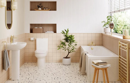 White vanity and close-coupled toilet in a bright bathroom interior