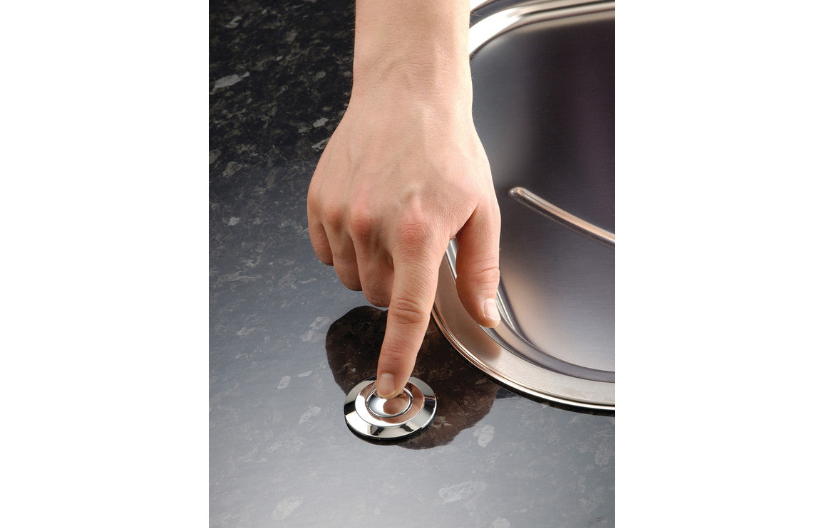 Multi Air Switch with round chrome button on kitchen sink countertop