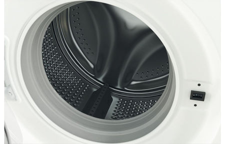 Washing machine door close-up with visible drum and perforated metal tub