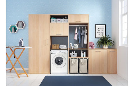 White freestanding washing machine installed in a room with matching cabinetry