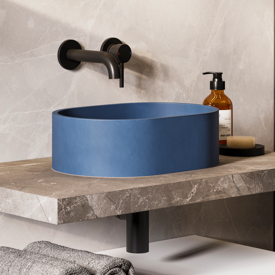 Cobalt blue pill-shaped concrete vessel basin with centered drain opening