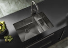 Stainless steel double-bowl kitchen sink with central divider and round drain strainers