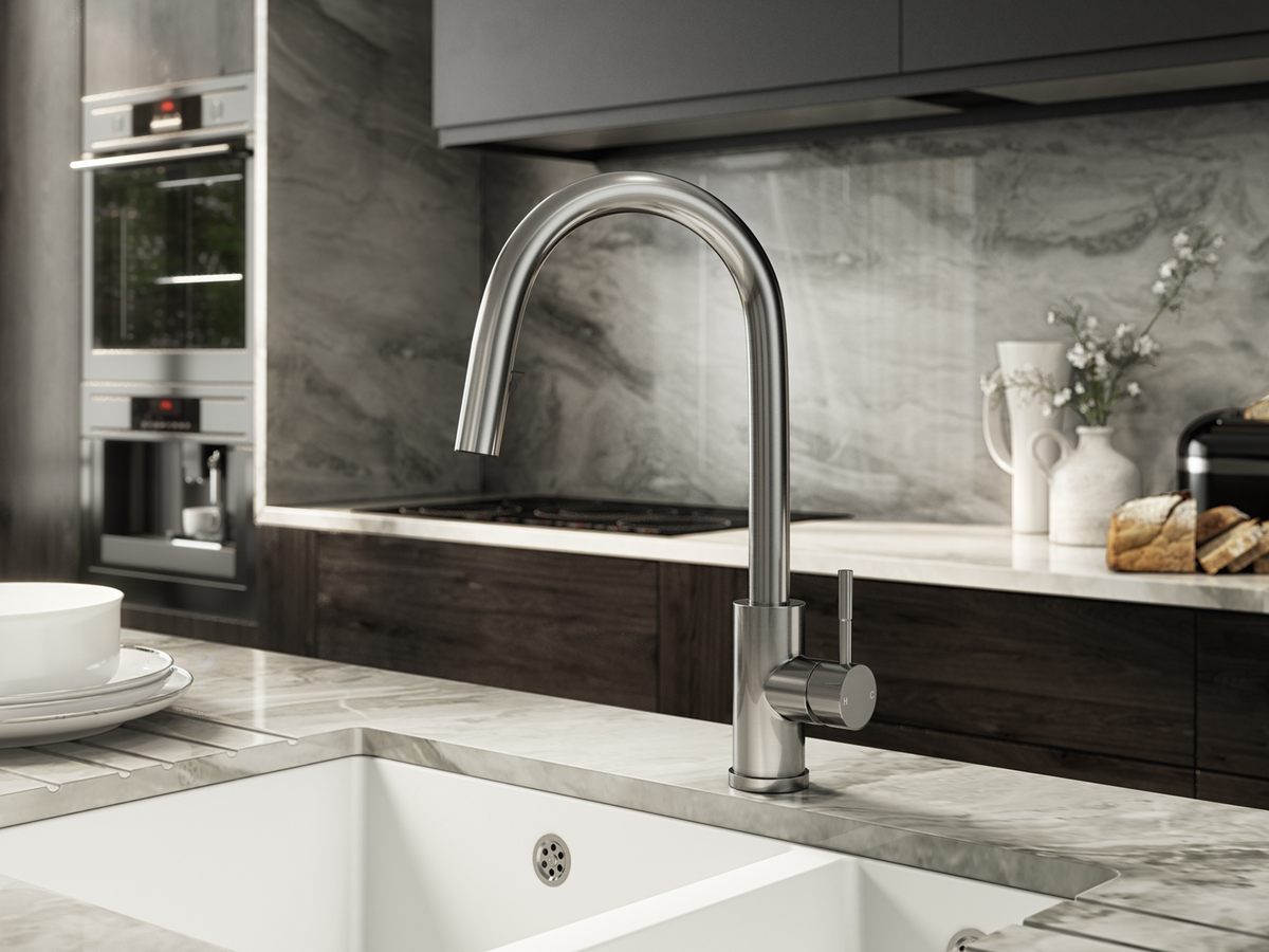Brushed steel kitchen mixer tap with pull-out sprayer over sink