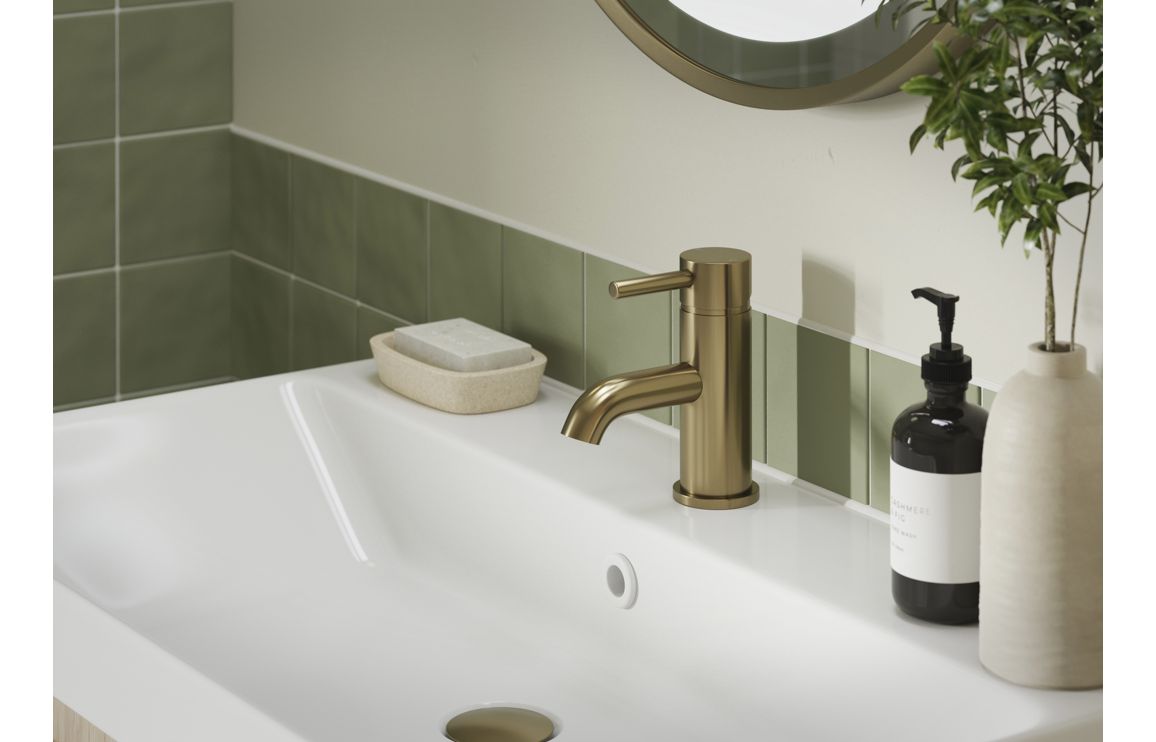 Brushed bronze two-handle bath faucet installed on a sink deck