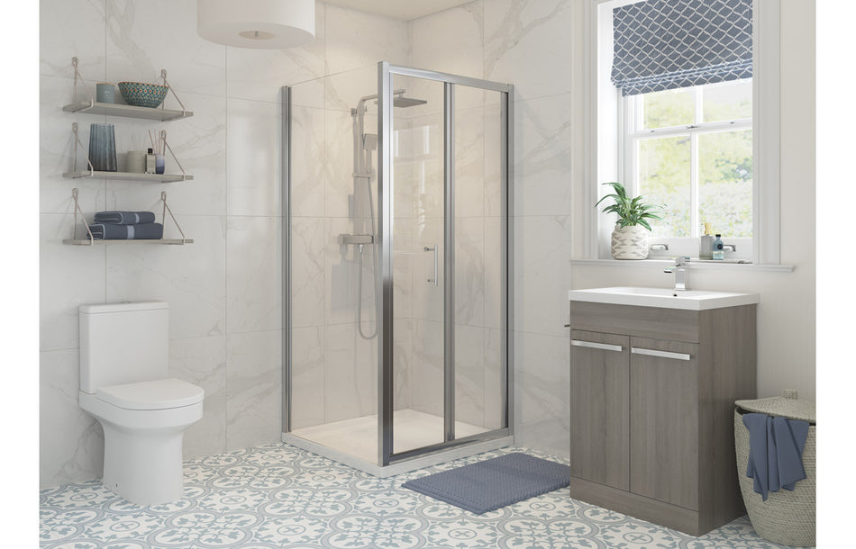 Bi-fold shower door in chrome frame with clear glass panels and pivot hinges