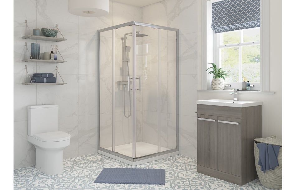 Chrome corner shower enclosure with clear glass panels and sliding entry door