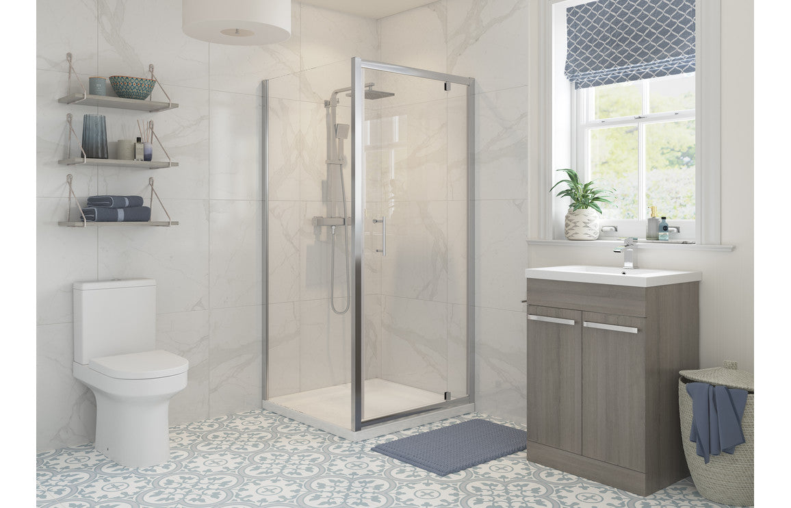 Chrome framed clear glass shower enclosure with hinged door and side panel