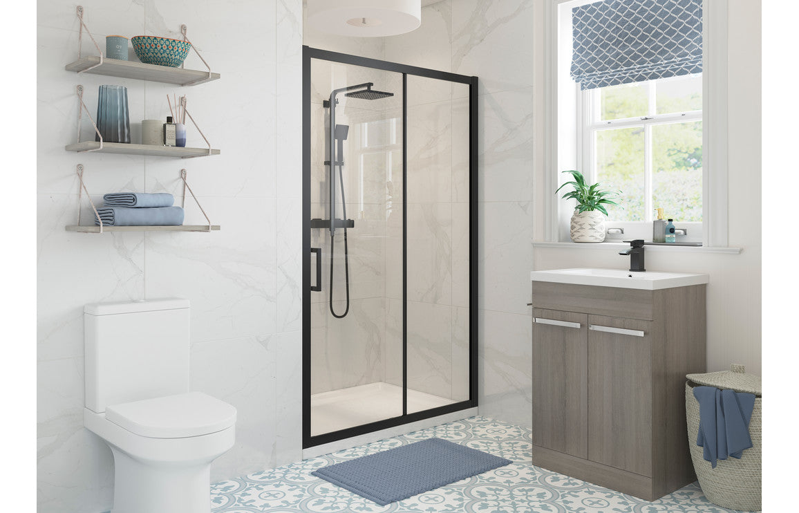 Black framed glass sliding shower door with fixed panel and handle