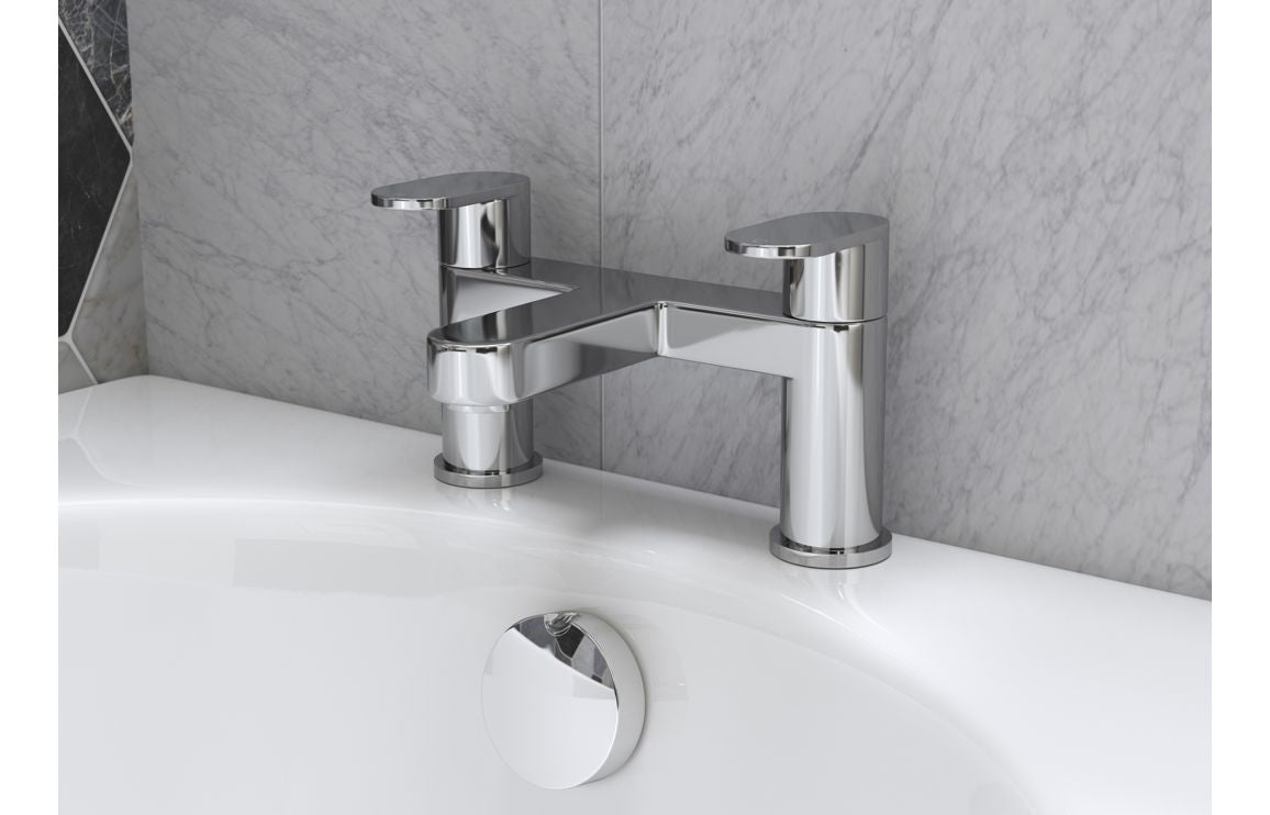 Chrome bath mixer taps with tall cylindrical spouts and single control on sink