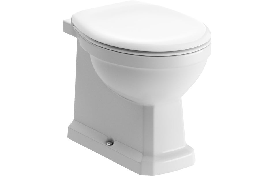 White back-to-wall toilet with closed soft-close seat, front three-quarter view