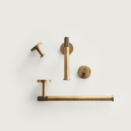 Brushed brass bathroom accessory set with towel rail, toilet roll holder, and hooks